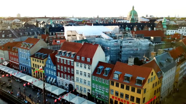 sunset-footage-from-Copenhagen,-Denmark.-Nyhavn-New-Harbour-canal-and-entertainment-district.-Aerial-Video-footage-view-from-the-top.-the-camera-rotates-in-a-circle.-Sunset-golden-time-light.