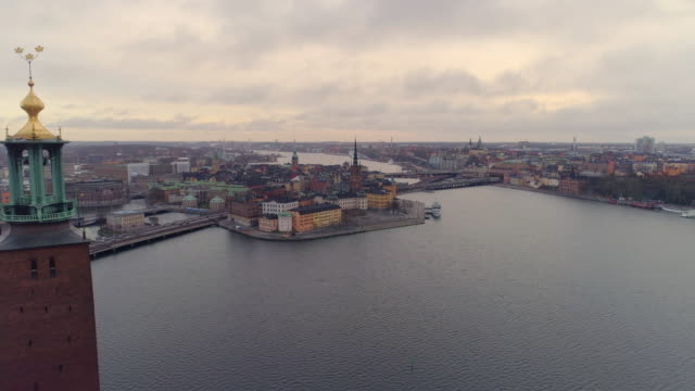 Aerial-4K:-Stockholm-city-center.-Flying-by-The-City-Hall-tower-and-towards-Gamla-stan-and-Riddarholmen-cityscape-skyline