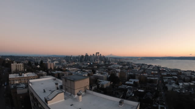 Building-Top-Aerial-Reveal-of-Seattle-Cityscape-and-Mt-Rainier