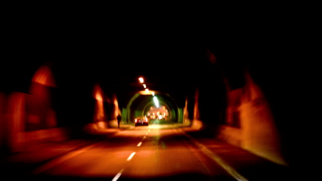 Drive-through-a-dark-urban-tunnel-at-night-(in-HD)