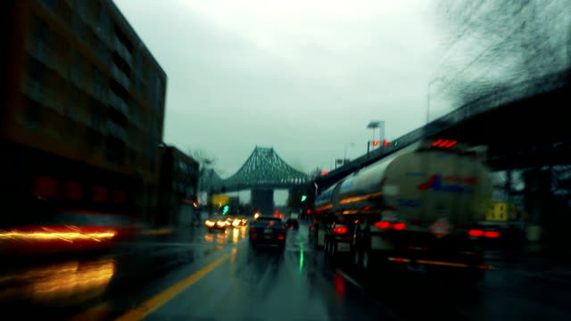 Time-Lapse-of-a-Rainy-evening-in-a-car-with-Bridge-in-Background