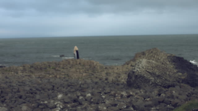 4k-Fantasy-Shot-on-Giant's-Causeway-of-a-Queen-Standing-on-Stones