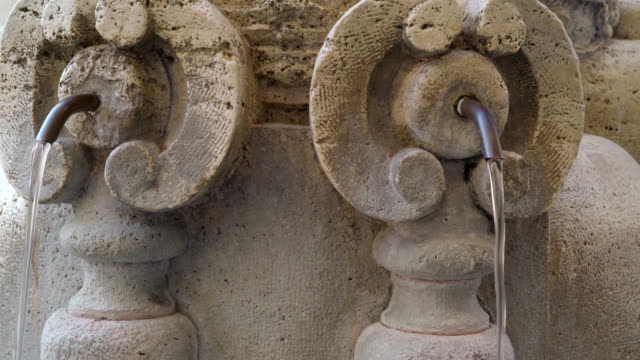 Small-hoses-on-the-water-fountain-outside-the-basilica-in-Vatican-Rome-Italy