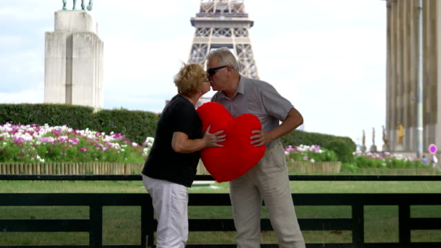 Senior-couple-kissing-in-front-of-Eiffel-tower-in-4k-slow-motion-60fps
