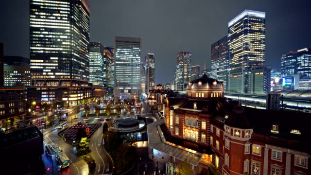 Tokyo-railway-station-with-high-rise-buildings.-Downtown-and-financial-district-and-business-centers-in-smart-urban-city-in-Tokyo-at-night,-Japan