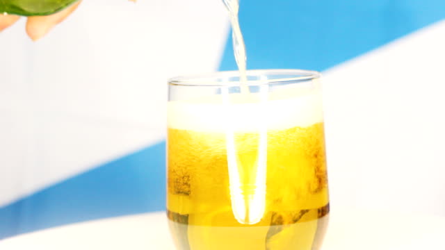 close-up-shot-of-pouring-beer-into-the-glass-in-front-of-the-bavarian-flag