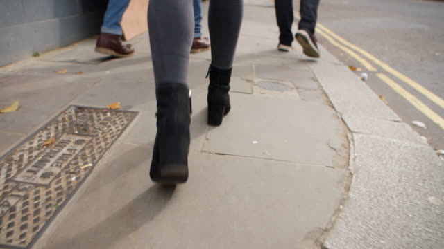 Close-Up-Of-Feet-Walking-Along-City-Street