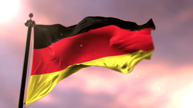 Bandera-de-Alemania-que-agita-en-el-viento-lento-en-puesta-de-sol,-lazo
