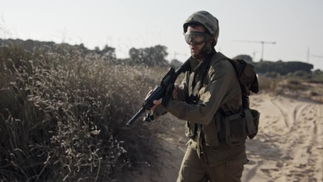 Israeli-soldier-pointing-his-rifle-and-scanning-the-area---slow-motion