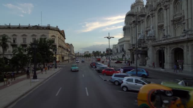 classic-1950's-American-Vintage-Taxi-Car-driving-on-iconic-street-old-Havana,-Cuba