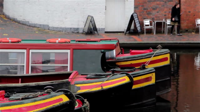 Close-Up-of-Three-Narrow-Boat-Barges-Lined-in-a-Row