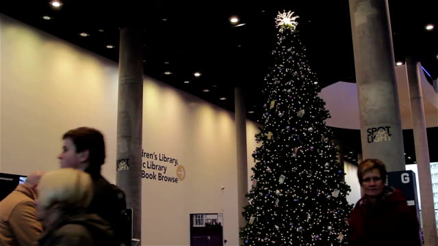 Tilt-Down-Large-Christmas-Tree-in-Birmingham-as-people-enjoy-Xmas-Lights
