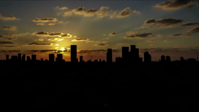 City-skyline-time-lapse-orange-sunset-into-night