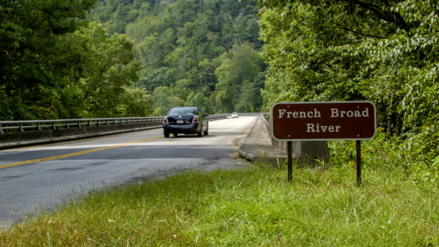 Vehicle-Traveling-Over-French-Broad-River-in-Asheville,-NC