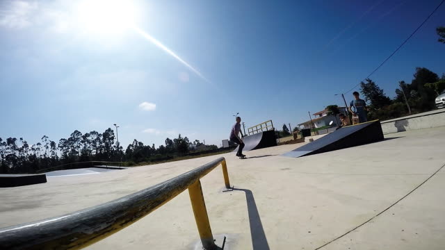 Skateboarder-sliding-down-rail