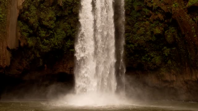timelapse-pan-up-Ouzoud-Waterfalls-located-in-the-Grand-Atlas-village-of-Tanaghmeilt,-in-the-Azilal-province-in-Morocco,-Africa