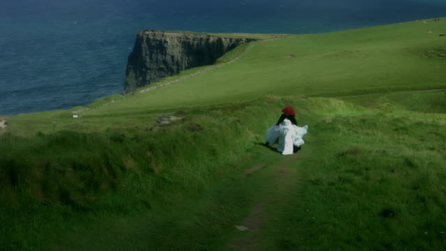 4k-Shot-of-a-Redhead-princess-walking-on-Cliffs-of-Moher-View-in-Ireland