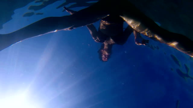 Unterwasser-Schuss-von-attraktiven-und-verspielte-paar-Schnorcheln-und-schwimmen-auf-der-Wasseroberfläche