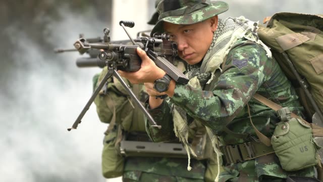 Soldier-holding-gun-weapon-and-waring-armor-uniform.-The-military-is-responsible-for-maintaining-the-territory.