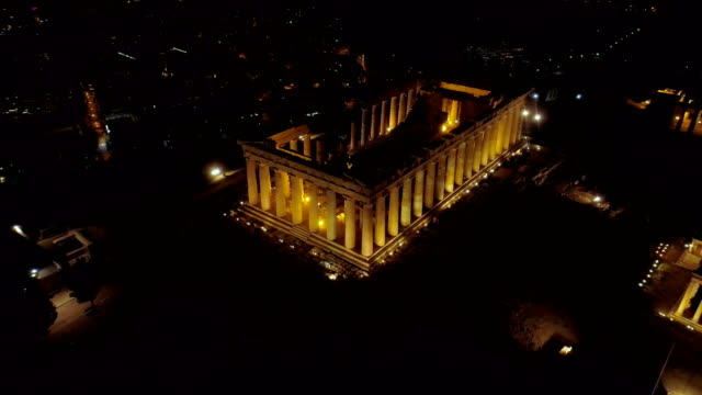 Aerial-night-video-of-iconic-ancient-Acropolis-hill-and-the-Parthenon-at-night,-Athens-historic-center