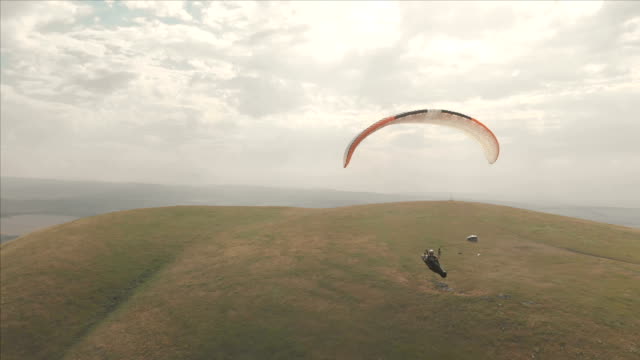 Athlete-paraglider-flies-on-his-paraglider-next-to-the-swallows.-Follow-up-shooting-from-the-drone