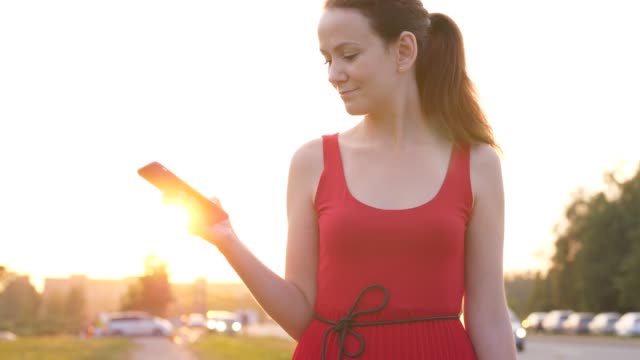 Glückliche-Frau-im-roten-Kleid-mit-Smartphone,-Stadt-Lifestyle-Konzept