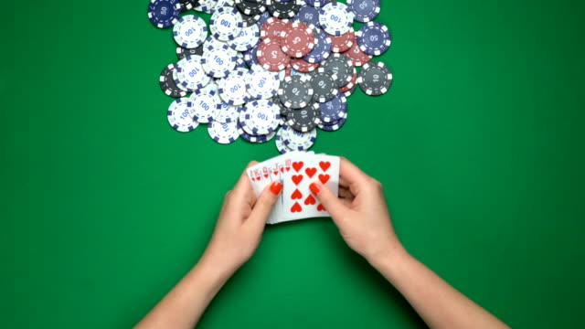 Poker-player-fanning-royal-flush-combination,-winning-the-game,-top-view