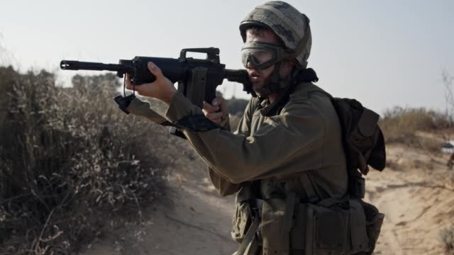 Israeli-soldier-pointing-his-rifle-and-scanning-the-area---close-up
