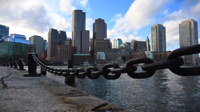 Timelapse-of-the-downtown-Boston-financial-district-skyline-as-viewed-from-Seaport-across-Boston-Harbor