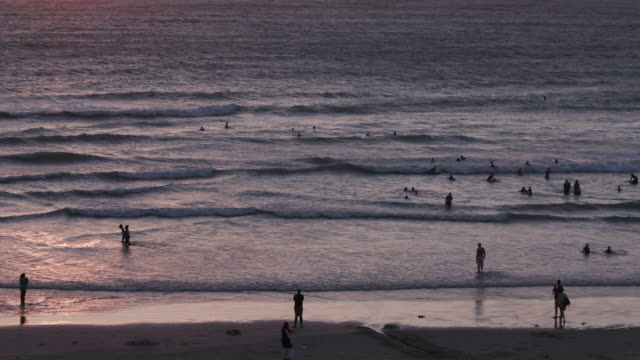 Menschen-Schwimmen-ein-Sonnenuntergang-an-einem-Strand-von-Cape-Town,-Südafrika