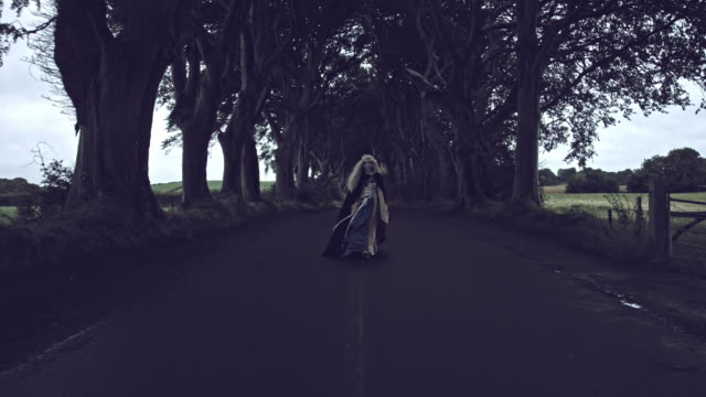 4k-Fantasy-Shot-in-Dark-Hedges,-Queen-Walking-to-Camera