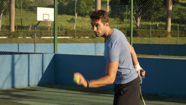 Guy-hitting-tennis-ball