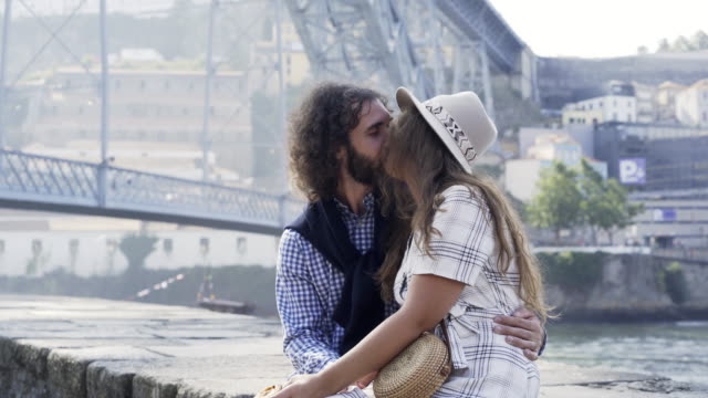 Couple-kissing-on-embankment-in-Porto