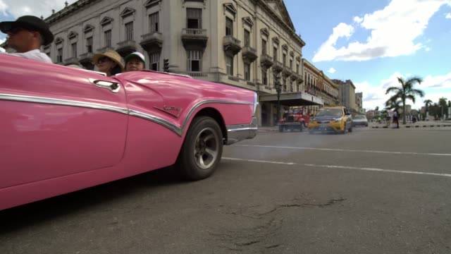 Classic-1950's-American-Vintage-Cuban-Convertible-Taxi-Cars-driving-on-the-street-of-Havana-city,-Cuba.