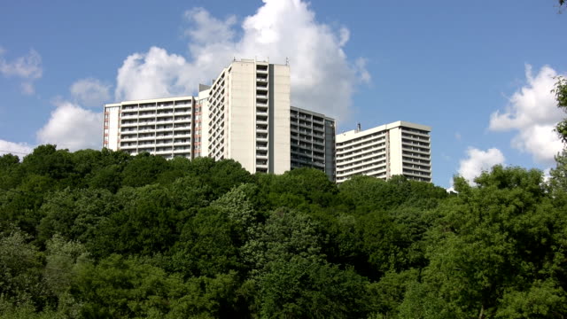White-apartments-on-green-hillside.