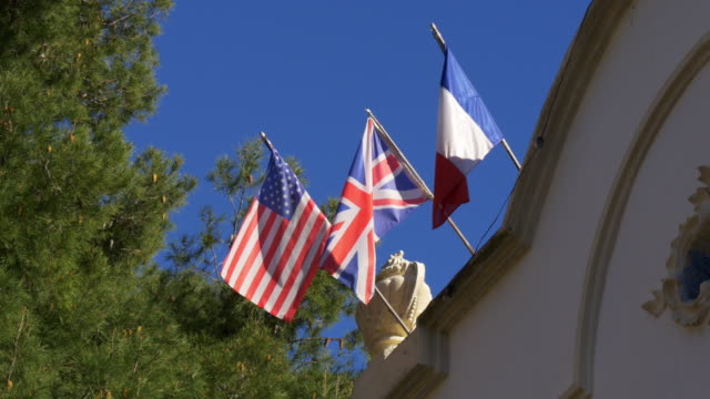 Luz-solar-american-Inglaterra,-Francia-flags-cielo-azul-4-k,-España