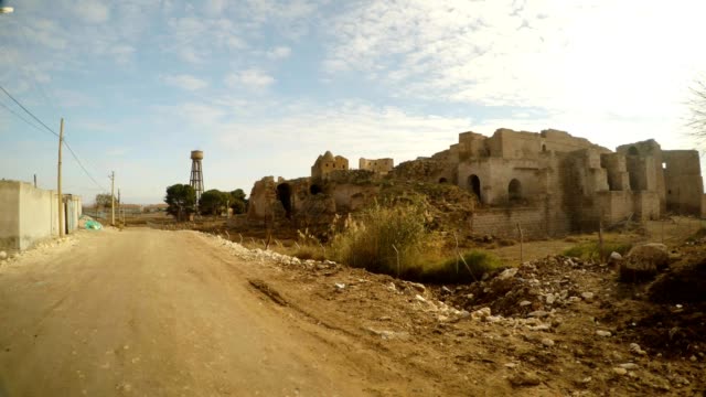 street-in-a-deserted-village-and-a-ruined-castle-in-the-south-east-of-Turkey,-on-the-border-with-Syria
