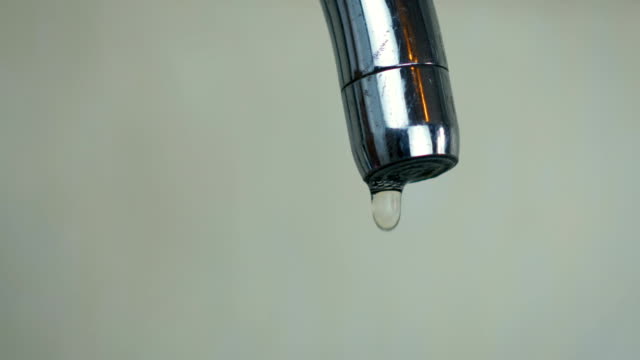 Close-up-abstract-a-droplets-of-water-drip-from-the-tap-in-the-kitchen-at-home.
