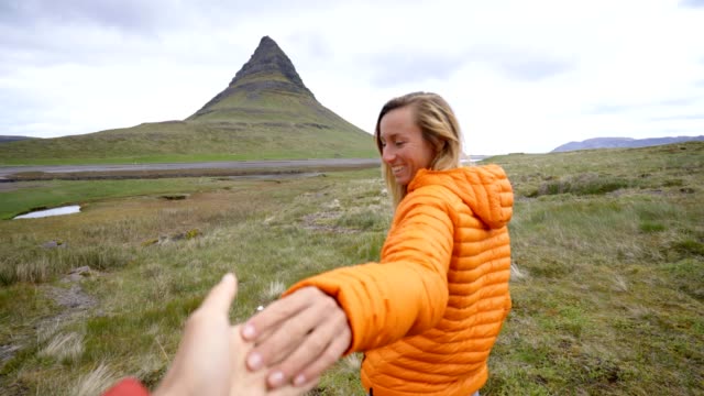 Follow-me-to-nature,-girlfriend-leading-man-to-Kirkjufell-mountain