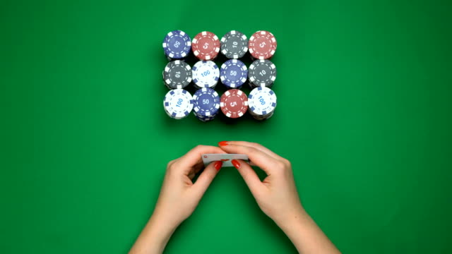 Poker-player-holding-strong-hand,-pair-of-aces,-successful-game,-top-view