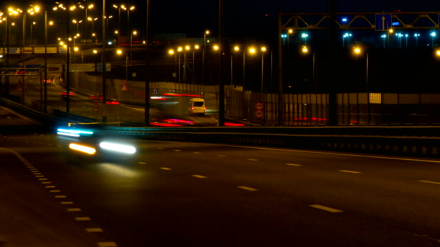 Highway-traffic-cars-at-night-time-lapse.-Cars-moving-on-road-on-bridge-evening-timelapse.-4K-UHD.-Timelapse.