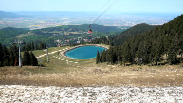 Cable-car-and-lake-viewed-from-Postavaru-peak,-Brasov,-Romania,-4K