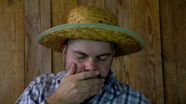The-man-in-the-straw-hat-yawns
