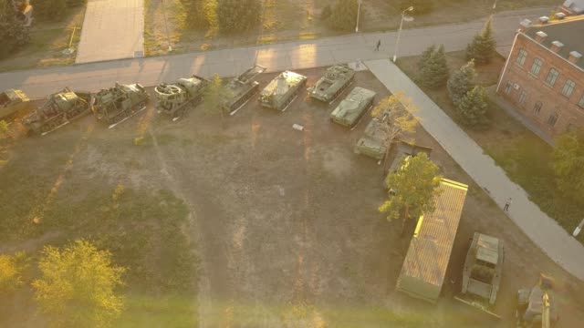 aerial-view-of-row-of-military-vehicles-machines-during-sunset