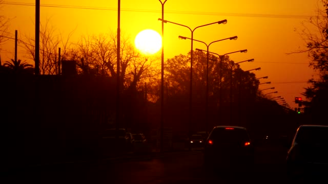 Verkehr-mit-Orange-Sonne-am-Himmel.