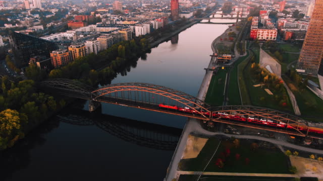 Frankfurt-Aerial-River-Shot-at-early-sunrise-train-over-bridge