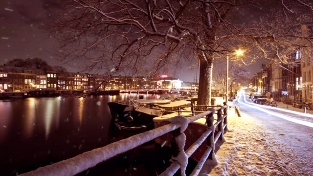 Snowing-in-Amsterdam-Netherlands-at-night-in-winter