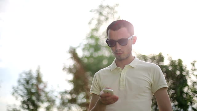Man-outdoors-talking-on-the-phone.-Slow-motion