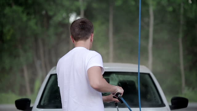 man-in-a-white-t-shirt-white-car-washes.-Slow-motion