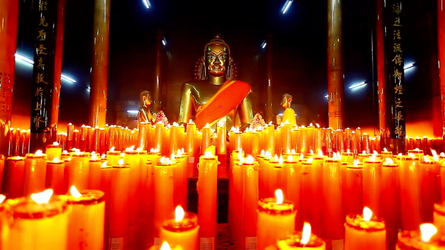 Dolly,-Buddha-Statuen-mit-Kerzen-in-Tempel